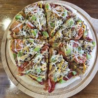 Cheezy Beefless Pizza:
Homemade cashew cream cheese, tomato sauce, vegan beef, green capsicum, cherry tomato, vegan mozzarella cheese, mix herbs. at nomVnom Bistro - Clarke Quay in Central Singapore