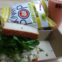 Beans Simmons chickpea sandwich on gluten-free bread, Miss new fruity smoothie, vegan popcorn at The Juice Box in Lakeland