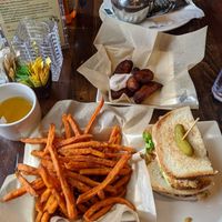Sweet potato fries, vegan tuna sandwich, plantains with vegan sour cream, tumeric ginger tea at Busboys and Poets - Carroll St in Washington