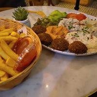 Golema plate (hummus, falafel, vegetables fresh and pickled) with fries at Mango Vegan Street Food - Bracka in Warsaw