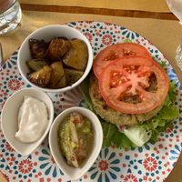 Vegan burger and baked potatoes with vegan mayo and avocado. at Quinoa in Florence
