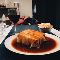 vegan francesinha and wine  at Lupin Restaurante Vegetariano in Porto