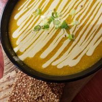 Pumpkin daily soup with a cracker and gluten-free bread at Indigo Age Cafe in Vancouver