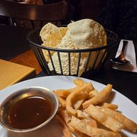 The dough sticks came as an amuse. Basket of papadams is a starter. 4,50€!! at Taj Mahal in Bruges