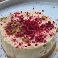 Vegan cheesecake with shaved raspberry and passion fruit at roots in Thessaloniki