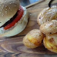 Vegan burger with black bean mushroom patty and baby potatoes at roots in Thessaloniki