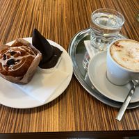 Cappuccino, muffin, and chocolate cone at Maran Vegan Bistro in Vienna