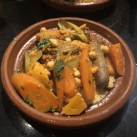 Cous cous with veg and vegan sausage  at Oranaise Cafe in Leeds