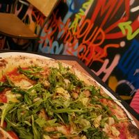 pizza with vegan chicken, vegan pesto and rocket salad at Morelli Zorelli in Brighton