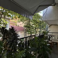 Upstairs patio with two small tables  at Backyard Cafe - Riverside in Phnom Penh