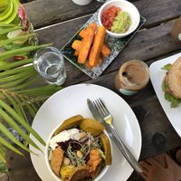 abundance bowl, ice coffee with cashew milk, sweet potato fries  at Backyard Cafe - Riverside in Phnom Penh