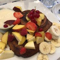 Vegan pancakes with yoghurt and fruit . Ask for soy  yoghurt and no honey  at Casamadie in Cesena