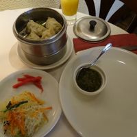 Main dish of steamed dumplings with noodle salad and sauce at Pema Thang in Paris