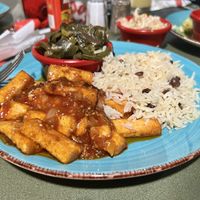 Brown stew tofu with collards, rice and peas, and Caribbean slaw  at Red Stripes Caribbean Cuisine and Lounge in Bluffton