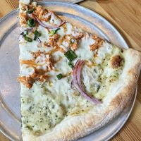 Vegan Buffalo 666: Shredded Buffalo Jackfruit, Follow Your Heart Vegan "Mozzarella," Red Onions, fresh Green Onions, Vegan Ranch and Wing Sauce  at Sizzle Pie - W Burnside in Portland