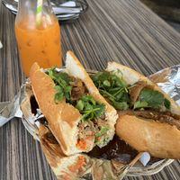 Lemongrass beef banh mi with a Thai iced tea in the background  at The Purple Mint - El Cajon Blvd in San Diego