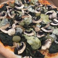 Spinach pizza with mushrooms, artichoke, olives and vegan cheese  at Fleischfrei in Dusseldorf