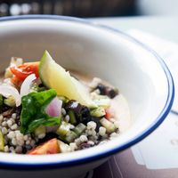 Bio sorghum tabulé with celery, cucumbers, red onion, tomatoes, basil, olives, origan and raspberries and yellow peaches cold soup at Frulez in Bari