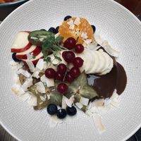 Pancakes buried beneath fruits  at FOAM in The Hague