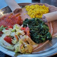 Vegetarian platter with yellow lentils, okra, spinach, salad and injera. at Saron in Heidelberg