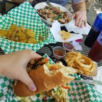 Fried Pickles appetizer, Cheesesteak with onion rings, and Bean Bowl with a biscuit at Bean Vegan Cuisine in Asheville