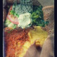 Veggie combo platter: red lentils, split peas, collard greens, salad, stuffed jalapeño on gluten free injera. Deliciously authentic Ethiopian. at Cafe Dareye in Oakland