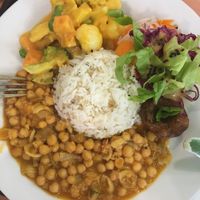 Daily menu, rice, chickpea stew, bean patty, veggies in creamy pumpkin sauce, salad at Mennyorszag Szive in Budapest