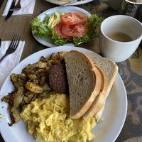 UNusual breakfast with potatoes, sourdough and veggie sausage + avocado and tomatoes; vanilla oat latte  at Crossroads Cafe in Joshua Tree