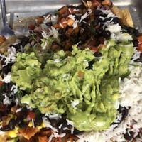 Veggie Nachos w/o sour cream or cheese with rice, black beans and guacamole added.  It was prettier before I dumped everything on it.   at Amigos Tortilla Bar in Key West