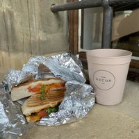 Vegan panini and cappuccino w/oat milk  at Cafe Einzigartig in Rothenburg Ob Der Tauber