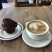 Oat milk latte with some kind of jam muffin   at Cafe Tuyo in Montreal