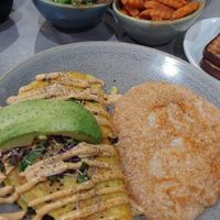 Just Egg and black bean omelette topped with avocado and microgreens with grits. With a side of sauteed veggies and sweet potato fries. at The Bossy Hen in Myrtle Beach
