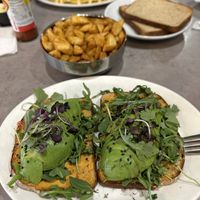 Avocado Toast comes with fresh fruit (came out before main dish and already ate it before pic.  Sliced banana, blueberries, strawberries.). Also got a side of home fries. #Veganuar at Hot Stacks Cafe in Myrtle Beach