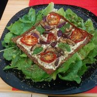 An excellent raw pizza of different seeds with dry tomatoes, kashew cheese and rúcula. at La Chakra in Lima