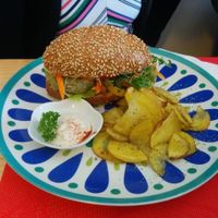 Two different small burgers in a seed bread with potatoes and vegan mayonnaise. at La Chakra in Lima