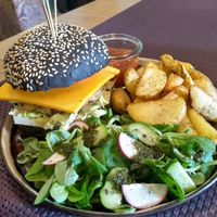 The side salad here was as tasty as the burger: fresh and light, ideal to go with the nice chunky potatoes and the savoury burger. at Bhajan Cafe in Riga