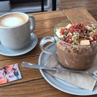 Cappuccino homemade almond milk and goji granola with apple and cacao topping  at Naspolya Nassolda in Budapest