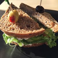Avocado sandwich with lettuce, tomatoes,  cucumbers
olives, sauerkraut, sprouts, macadamia and cashew cheese spread. at Nut Tree Cafe in North Vancouver