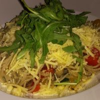 vegan spaghetti dish with olive oil, vegetables and grated non cheese at Pizzeria Manna in Prague