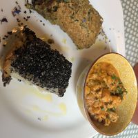 Main meal - curry, potatoes (with the black seeds on top) and a sorghum ‘tart'  at Fram Cafe in Bologna