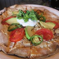 pizza with avocado and vegan chicken at Louisiana Pizza Kitchen in New Orleans