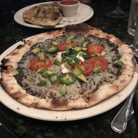 Roasted ‘chicken’ pizza without chicken as they ran out of vegan chicken - still very good  at Louisiana Pizza Kitchen in New Orleans