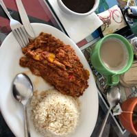 I think this one was shredded beef and it was served with rice and beans. I absolutely loved it! It was really flavorful and a bit sweet because of the yellow bell peppers. I’m a good eater but the plate will make you full haha. Also pictured in the green cup is a tropical tea latte with pineapple flavor. Trust me you HAVE to try it! I ordered it with almond milk. No sweetener added. I’m obsessed with this drink now!! at Equelecua Cuban Cafe - Cloud Kitchen in Los Angeles