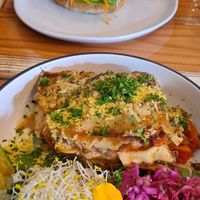 Lasagne & salad, jackfruit burger in background at Veggie Vie in Adelaide