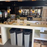 Coffee, condiment and trash area (no decaf)  at Thrive Juice Bar and Kitchen in Bar Harbor