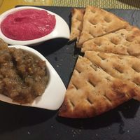 Beetrot hummus, aubergine paté, and pitta bread at Casa Griega in Barcelona
