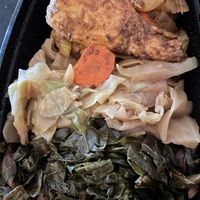 Jerk chicken, cabbage, and collard greens  at The Nile Cafe in Philadelphia