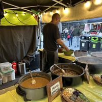 Stall with dishes and examples of servings- kind attendants  at Ethiopiques - South Bank in South East London