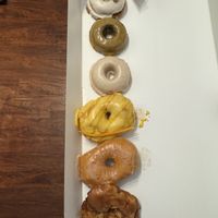 Half dozen with monthly specials baked carrot cake and mango passion fruit   at Cartems Donuts - Main St in Vancouver