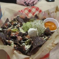 Nachos : freshly oven-baked organic tortillas, topped with melted Daiya cheese, guacamole, sour cream, fresh bruschetta, marinated jalapenos, and Copper Branch's signature mango pineapple habanero hot sauce.

Really good, and the sauce is extreme. at Copper Branch - 600 Maisonneuve W/O in Montreal